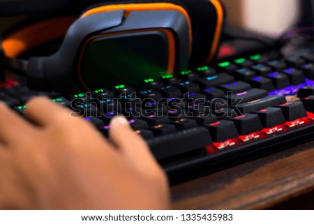 Game keyboard and headphones with blurry background