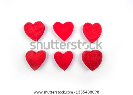 Small red wooden hearts isolated on the white background.