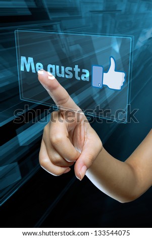 a woman finger select and like  on a spanish language digital screen