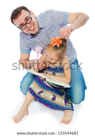The father reads to the daughter the book in studio on a white background the isolated