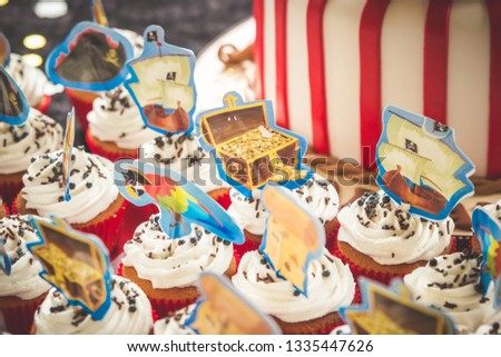 Pirate cupcakes kids birthday party treasure chest cupcakes with white vanilla icing and red paper with picture toppers decorations