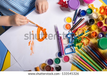 Hands of painting little boy