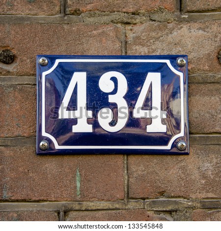house number four hundred and thirty four. White lettering on a blue enameled plate.