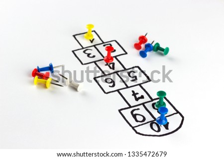 hopscotch game, child's play drawn on a white background with pins instead of players