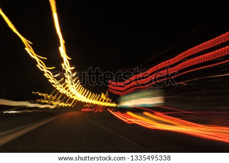 Highway seen at night, blurred street lamp lights, car lights, lines