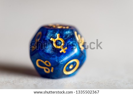 Astrology Dice with symbol of the planet Mercury on grey background