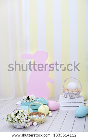 Easter! Many Easter eggs with bunnies and baskets of flowers! Easter room decoration and decor, children playroom. Colorful painted Easter eggs and rabbits. Spring home decor, spring flower