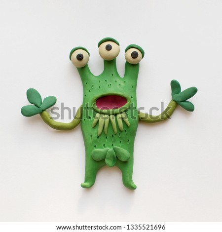 Funny three-eyed monster plant. Plasticine character on a white background Royalty-Free Stock Photo #1335521696