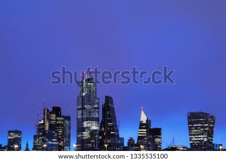 City skyscrapers and the skyline of London financial district illuminated at twilight