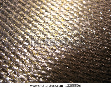 Real carbon fiber in its raw form - this is the material that is used to make strong, durable parts.  Shallow depth of field.