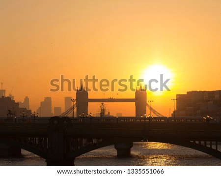Tower Bridge and London city skyline at sunrise