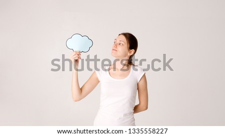 Young woman holding up a speech bubble icon with copyspace