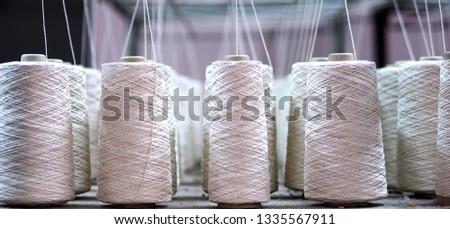 Row of textile threads industry .