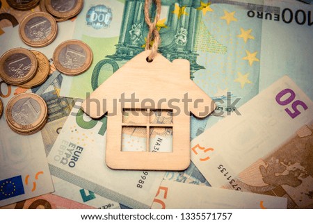 The symbol of the house stands on the background of the Euro 