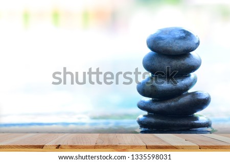 Wood table top on swimming pool  background.