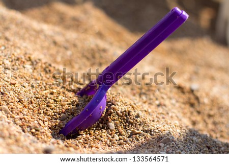 Children's beach toys on sand on a sunny day