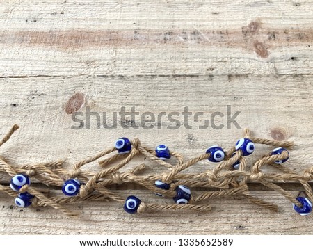 evil eye beads on wooden background