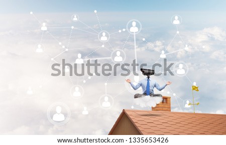 Faceless businessman with camera zoom instead of head sitting in lotus pose