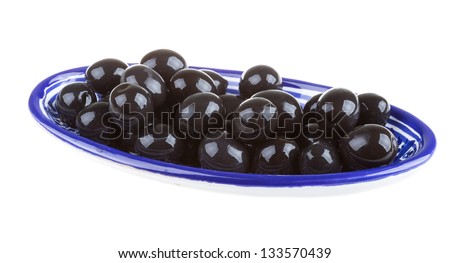 Olives black watered with olive oil in a bowl isolated on a white background