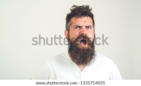 Bearded crazy man confused face. Angry man with beard with emotion, on white background. Emotion, face expression cocncept. Brutal bearded hipster with anger emotion. Copy space.