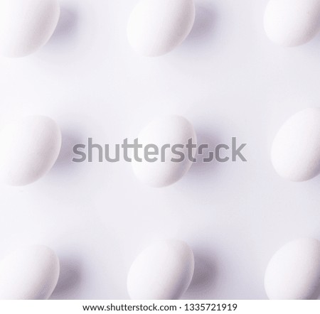 White eggs on a white background. Easter and spring flat lay. Top view.