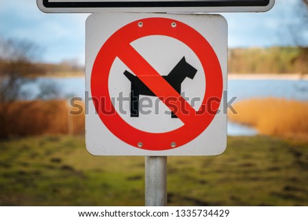 dogs not allowed sign at park or lakeside - no dogs sign with meadow background