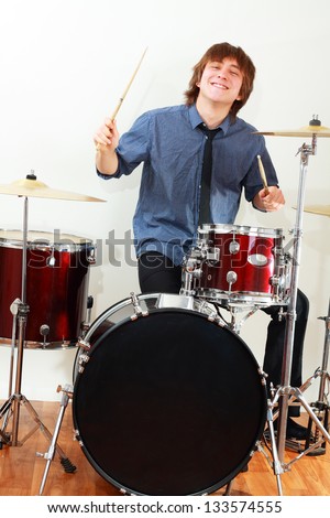 drummer man playing on drums studio shot