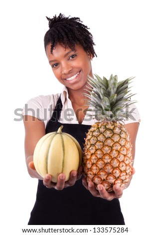 Young happy black / african american woman selling fresh fruits isolated on white background