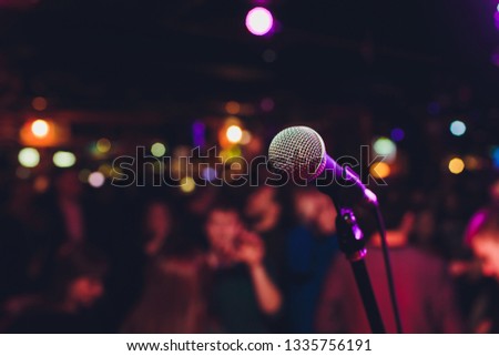 Microphone with blurred colorful bright light in dark night background, soft focus image for business technology communication concepts.