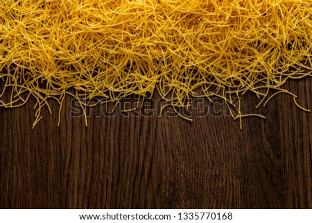 Uncooked pasta on dark background.