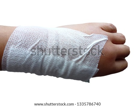 Close up of left hand of a woman with edema problem with band-aid around the hand, isolated on white background.    