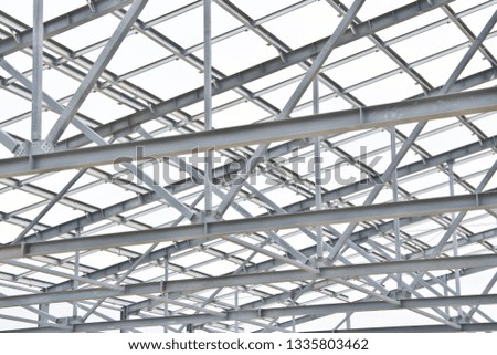 Structure of building from galvanized metal. Steel construction on sky background. Metal galvanizing technology to prevent corrosion.