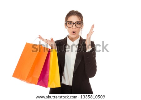 Closeup cutout portrait of a beautiful excited woman shopper holding many bags in hand overjoyed, ecstatic, customer girl wearing formal black suit and white shirt isolated on a pure white background