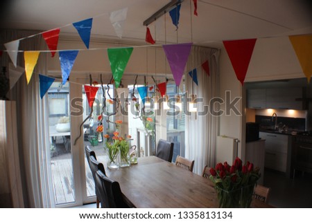 Beautiful living room with flowers and garlands, ideal background for a festive invitation.