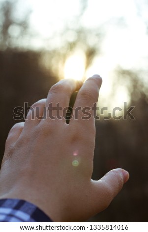 female hand and sunlight, sky