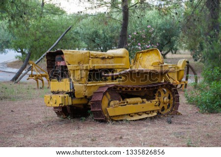 Abandoned bulldozer. yellow mechanical old man. Nature is stronger than technology