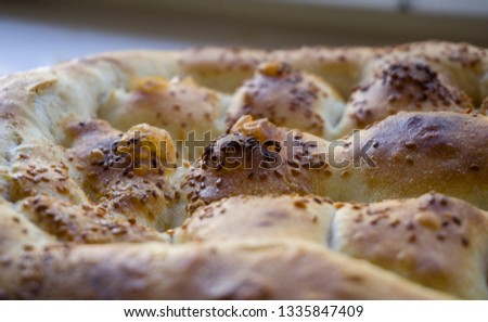 Close up of special Turkish Ramadan Pita. Turkish Ramadan bread. Traditional Ramadan food as known Pide. Turkish bread with sesame and nigella seeds. Turkish Ramadan Pita or Ramazan Pidesi. (Pide)