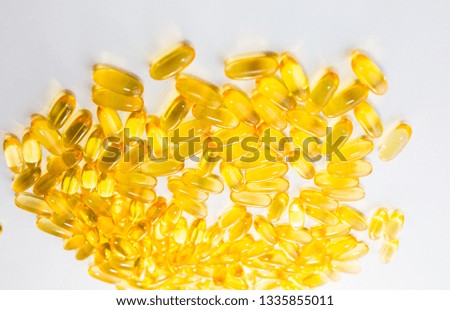 Omega 3 pills on white wooden background. Healthy diet supplements. Fish oils for vegans food.