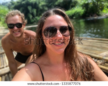 happy couple of light-skinned guy and girl on the sea in the tropics enjoy life , happy together. selfie