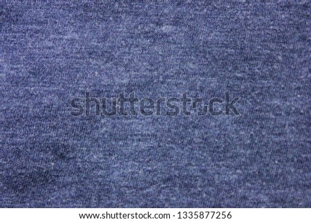 Pale navy blue texture background of soft cotton shirt fabric surface. Empty cloth material and plain design, flat lay top view of blue hoddie worn pattern