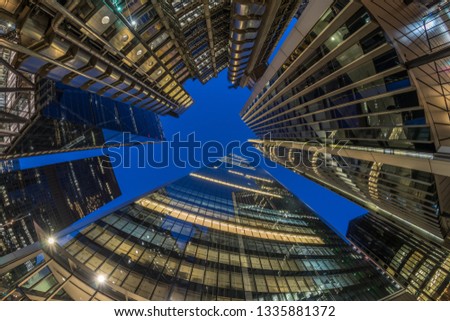London financial district, looking directly up at the city skyline at night