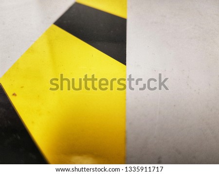 A closeup of yellow-black striped tape