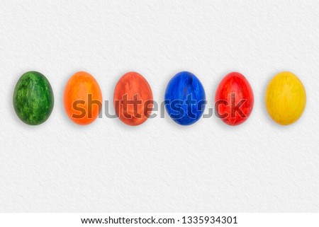 Easter eggs on white paper. Multicolored eggs on a paper background. A set of colored eggs