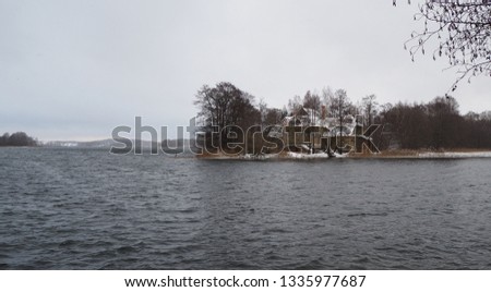 Camping in winter. Old wooden house on the lake. 