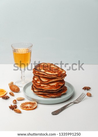 Honey pouring over a stack of mini pancakes. The concept of a delicious breakfast.