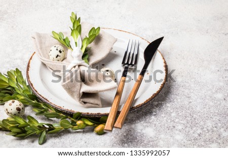 Easter table setting  on on gray background. Holiday decoration.Happy Easter concept. Copy space for Text.