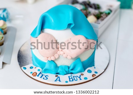 Cake in the form of children's ass with legs. Horizontal frame