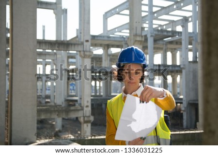 Female architect looking at the sketch