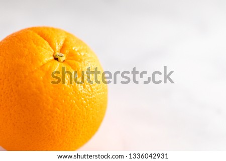 Fresh orange fruit on a white marble countertop 