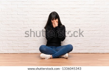 Woman sitting on the floor smiling a lot